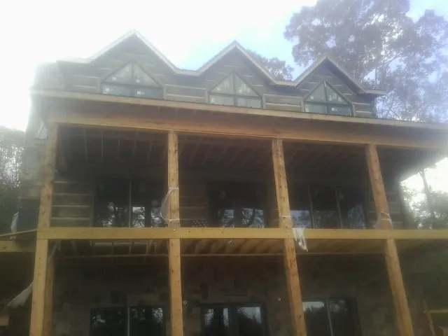 Dormers and porch framing on a large log home under construction in Zirconia